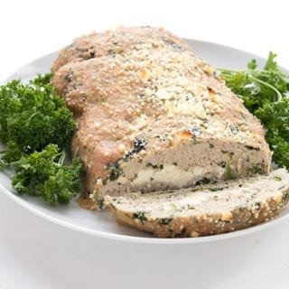 Healthy turkey meatloaf on a white plate with parsley
