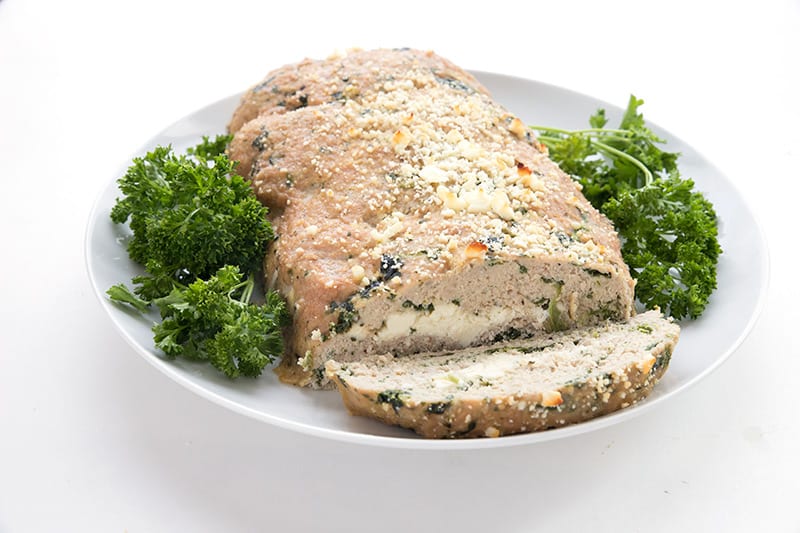 Healthy turkey meatloaf on a white plate with parsley