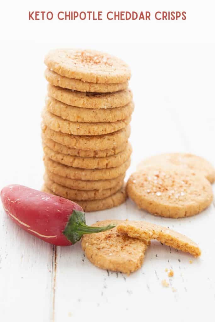Titled image of keto chipotle cheddar crisps in a stack, with a red jalapeno pepper