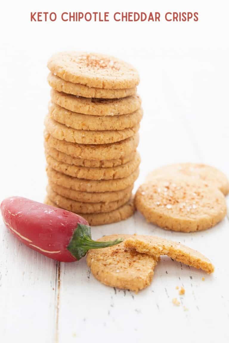 Titled image of keto chipotle cheddar crisps in a stack, with a red jalapeno pepper