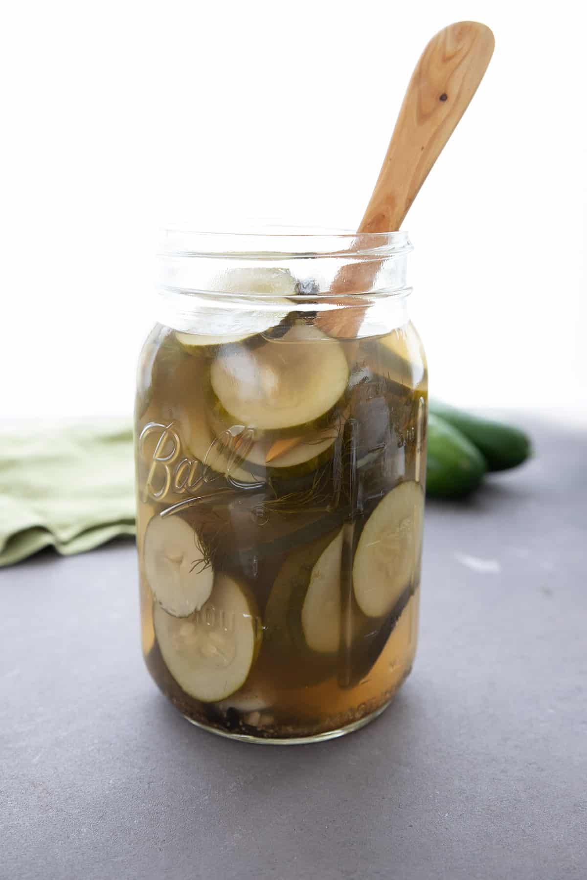 A large glass jar filled with keto pickles. 