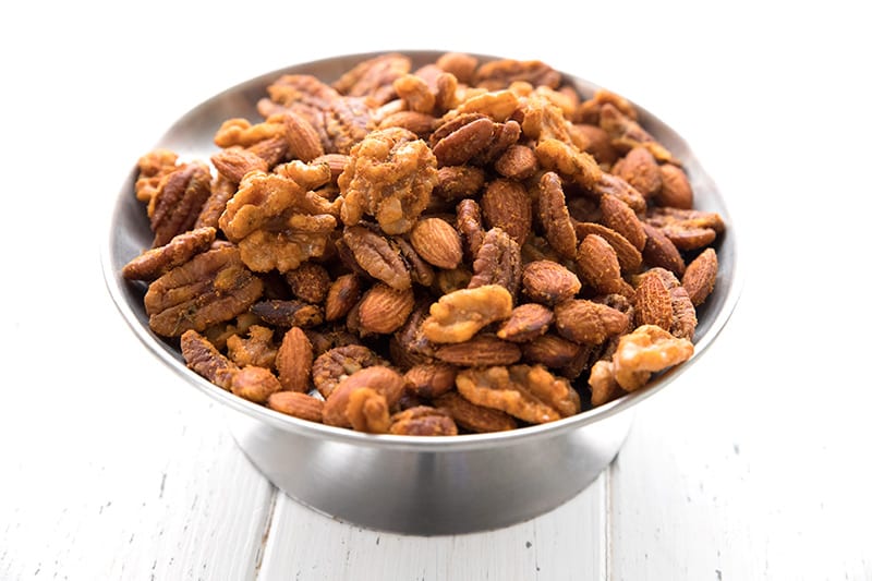 A metal dish piled with keto buffalo spiced nuts