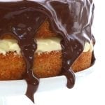 Close up of chocolate ganache dripping down the sides of a Boston Cream Pie