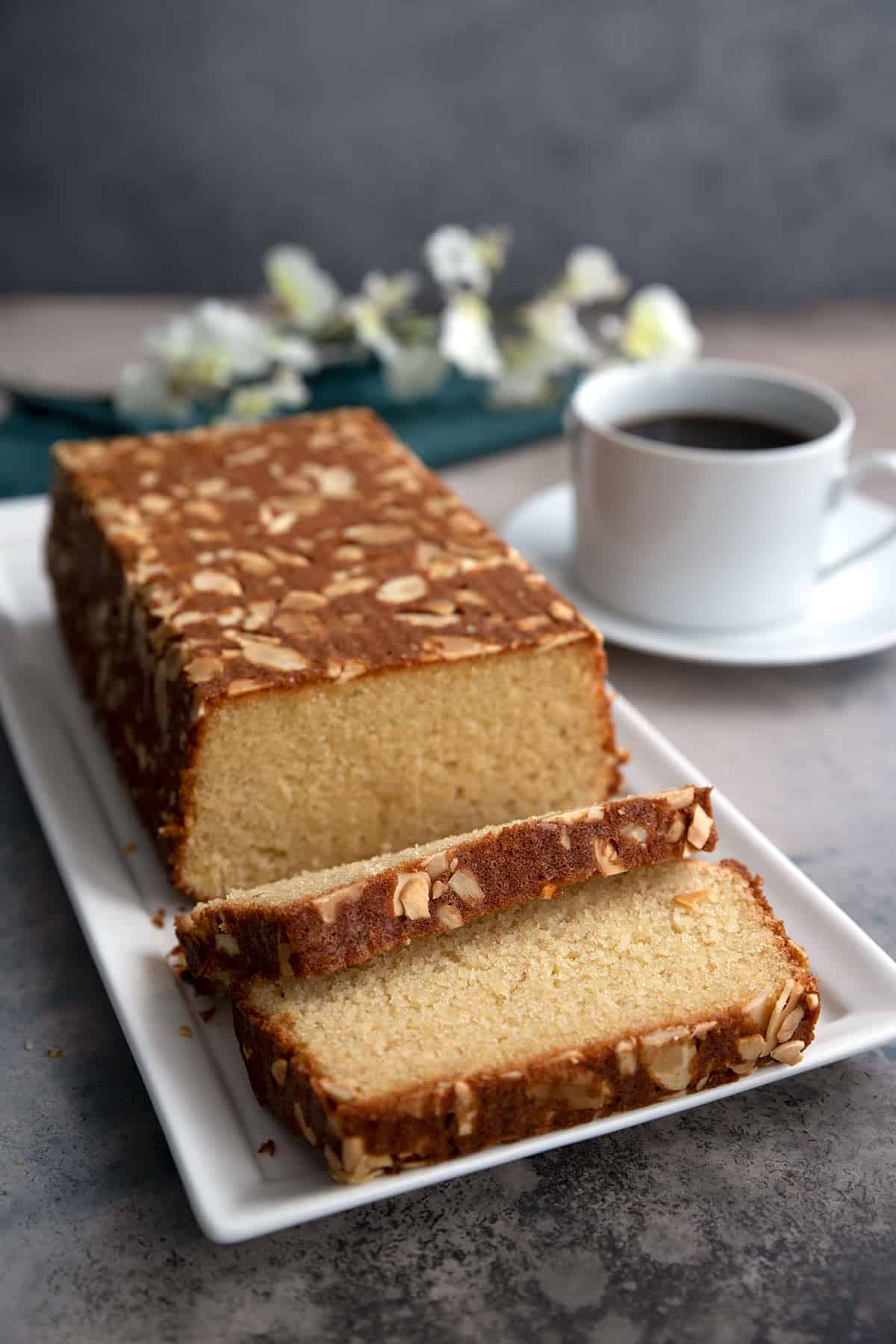 Almond flour cake sliced on a white rectangular tray.