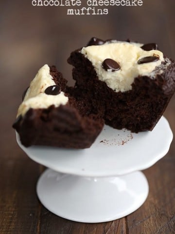 A keto chocolate cream cheese muffin on a cupcake stand, cut open to see the inside.