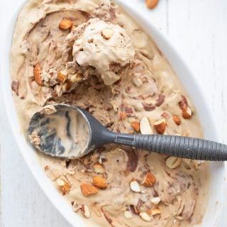 Top down image of keto jamoca almond fudge ice cream in an oval dish with a scoop taken out of it.