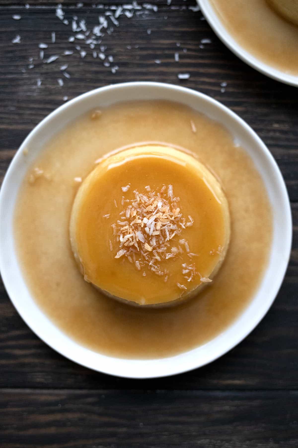 Top down image of keto coconut flan on a white plate