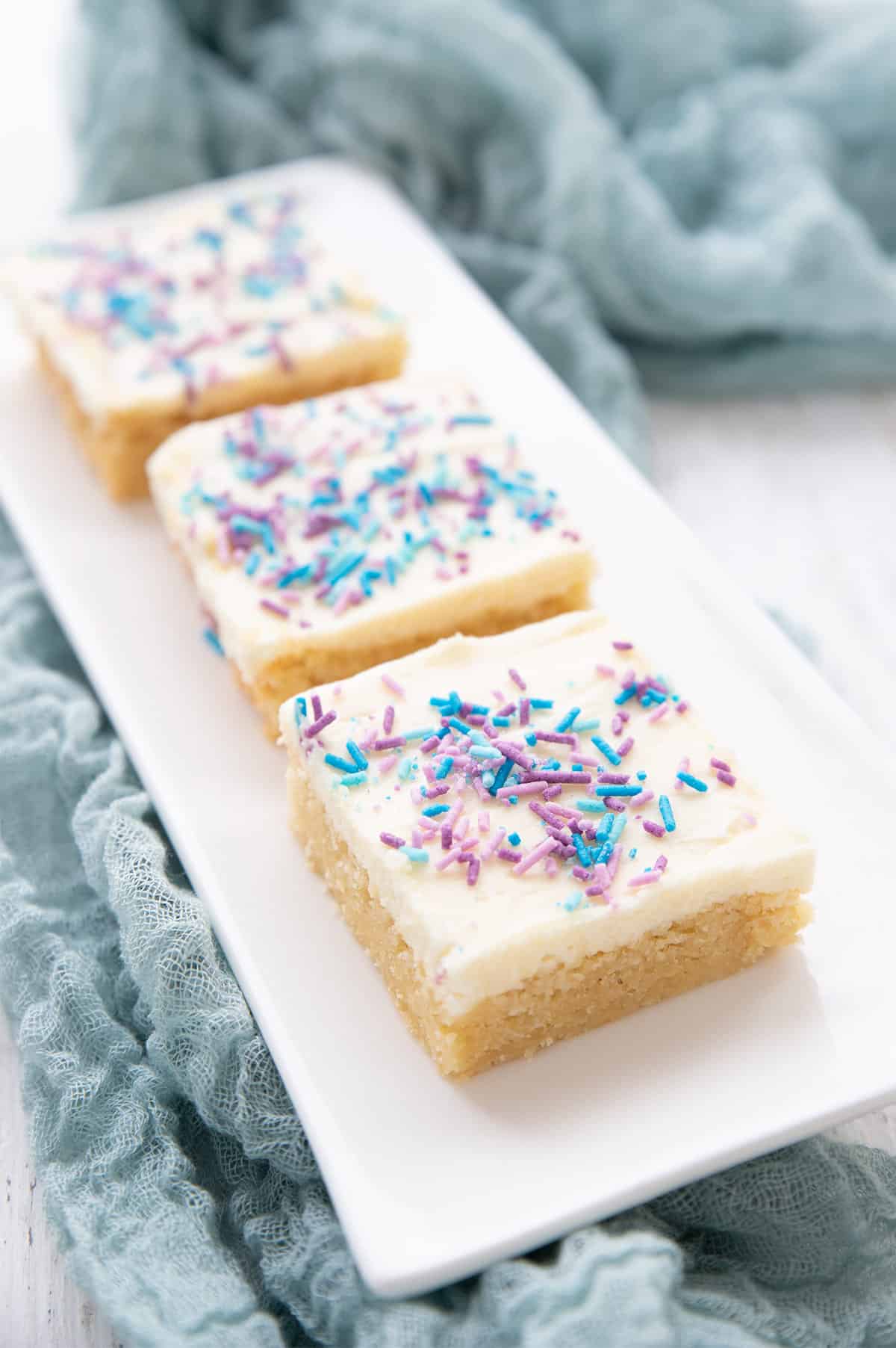 A white tray with Keto Sugar Cookie Bars in a row. 