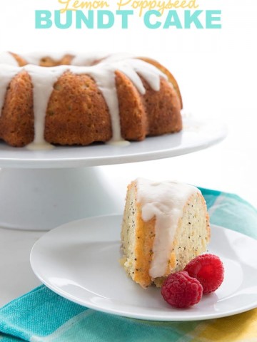 Keto Lemon Poppy Seed Cake on a white cake stand with raspberries