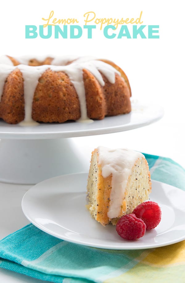 Keto Lemon Poppy Seed Cake on a white cake stand with raspberries