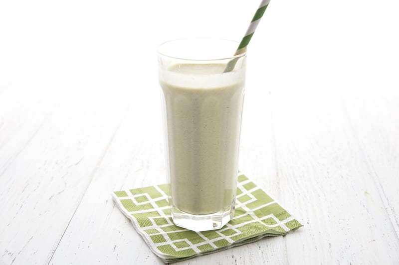 A keto green smoothie on a white table with a green napkin