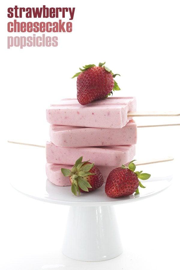 titled image (and shown): Strawberry Cheesecake Popsicles (a stack of sugar-free cheesecake popsicles made with fresh strawberries)