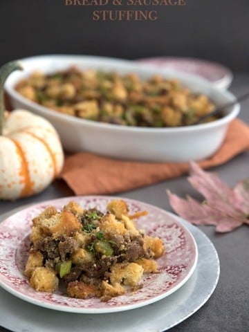 Keto Sausage Stuffing on a plate with pumpkins and maple leaves in the background