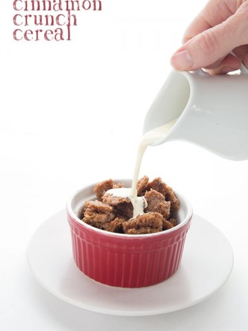 Easy low carb cereal in a red bowl with cream being poured into it.