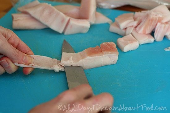 Cutting fat off pork skin