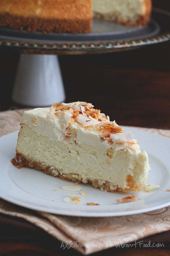 A slice of sugar free coconut cheesecake on a white plate
