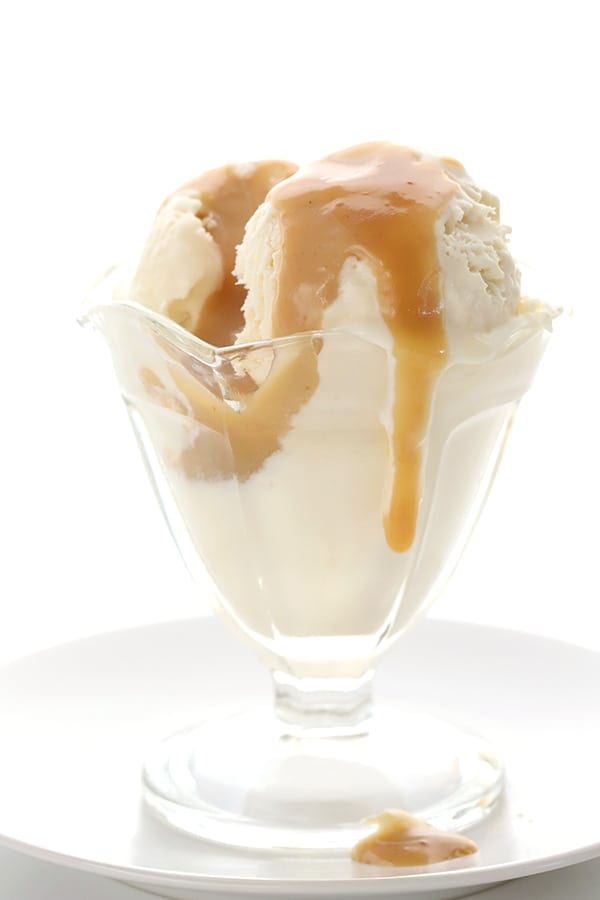 Close up shot of low carb vanilla ice cream with sugar free caramel sauce dripping down it