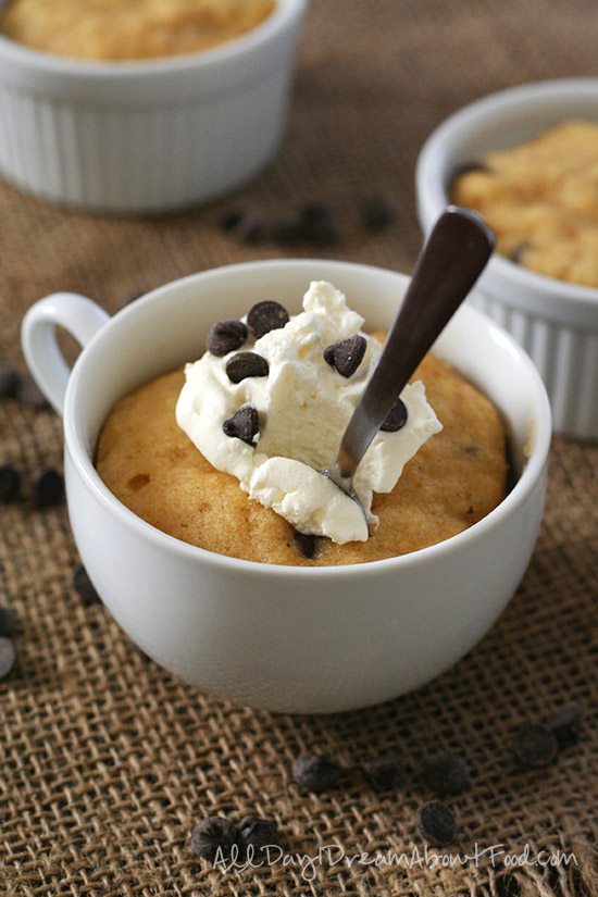Grain-Free Peanut Butter Mug Cake topped with sugar free whipped cream and chocolate chips
