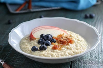 Coconut flour porridge with blueberries in a white bowl