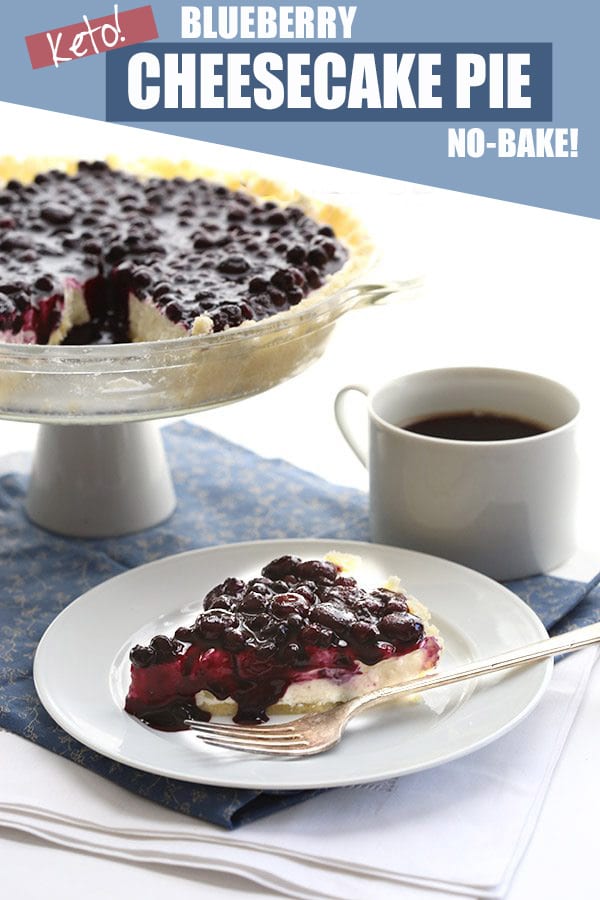 Blueberry cheesecake on a white plate with a blue napkin and a cup of coffee