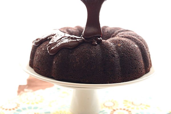 Low carb chocolate peanut butter ganache poured over a delicious chocolate bundt cake filled with peanut butter cheesecake!