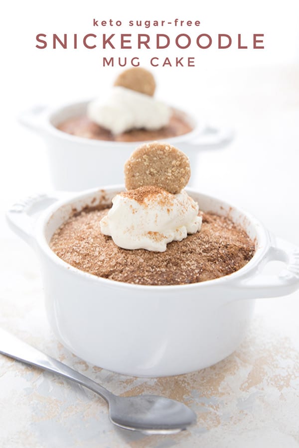 Titled image of two keto snickerdoodle mug cakes in white ramekins with whipped cream and mini cookies on top.