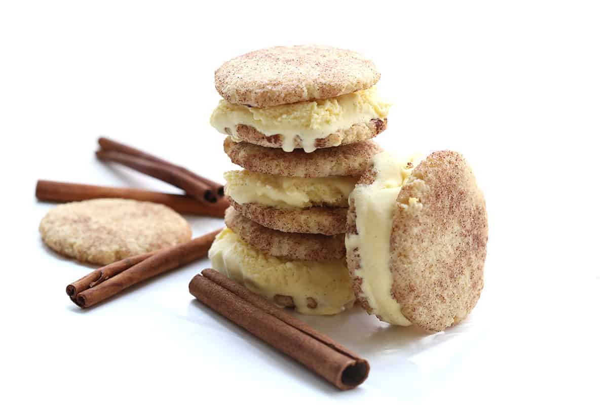 A stack of ice cream sandwiches with cinnamon sticks on a white background