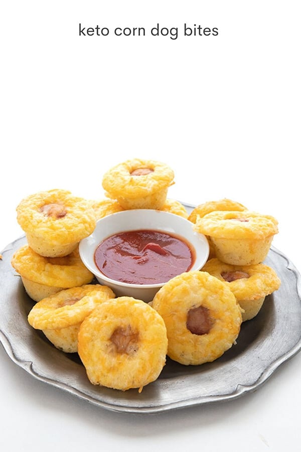 Easy keto corn dog bites on a pewter plate with a small bowl of sugar-free ketchup