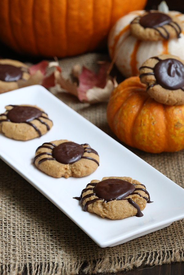 Low carb chocolate peanut butter thumbprints in the shape of spiders. A perfect sugar-free Halloween treat!