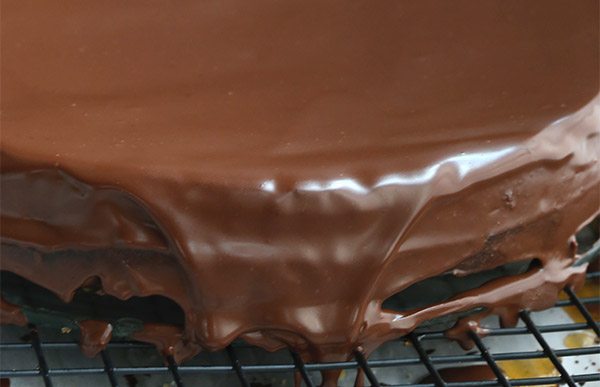 Low carb chocolate ganache spread over a rich, dense chocolate torte