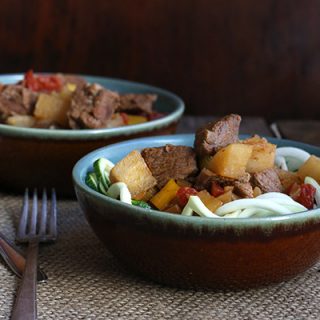 Low carb paleo Hungarian Goulash made with daikon radish and served over zucchini noodles