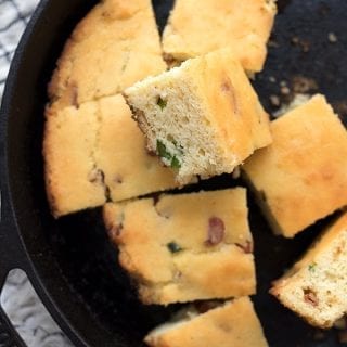 Top down photo of keto cornbread cut up in a cast iron skillet.