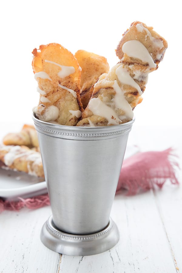 Keto fathead cinnamon pastries in a metal cup on a white wooden table