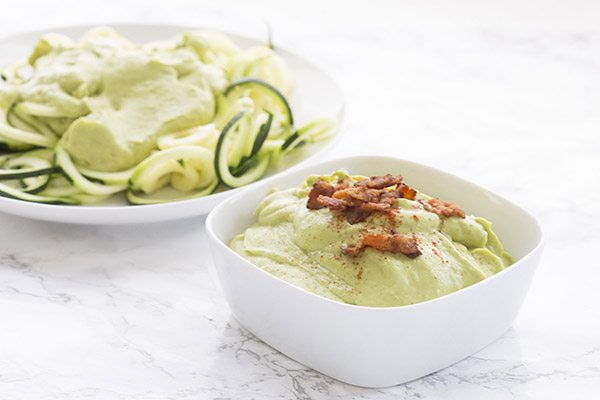 Rich creamy avocado sauce makes a great topping for zucchini noodles. Add some bacon too! Low carb, paleo, grain-free