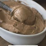 Close up image of keto chocolate avocado ice cream being scooped out of the container.