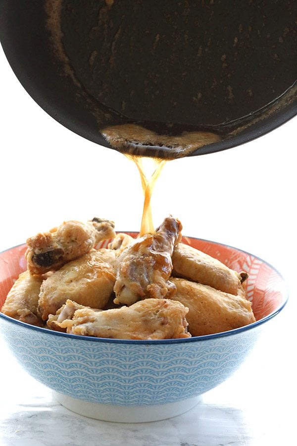 Pouring brown butter over crispy oven baked wings. Add a little Old Bay and these will become your favorite wings! Low carb, primal, grain-free, keto