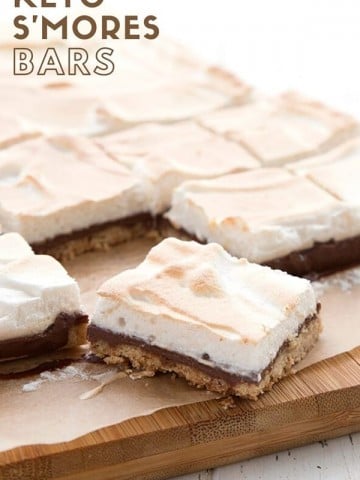 Titled image of keto s'mores bars on a cutting board, with one bar in front