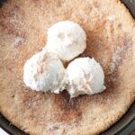 Top down image of Keto Snickerdoodle Skillet cookie with ice cream on top.