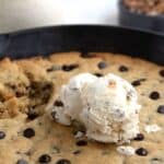 Titled image of Keto Chocolate Chip Skillet Cookie with ice cream on top.
