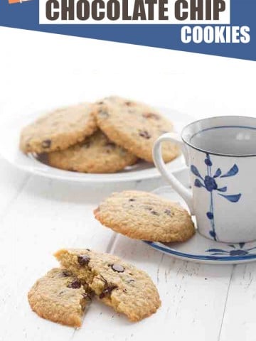 Chewy low carb chocolate chip cookies on a white table with a cup of coffee