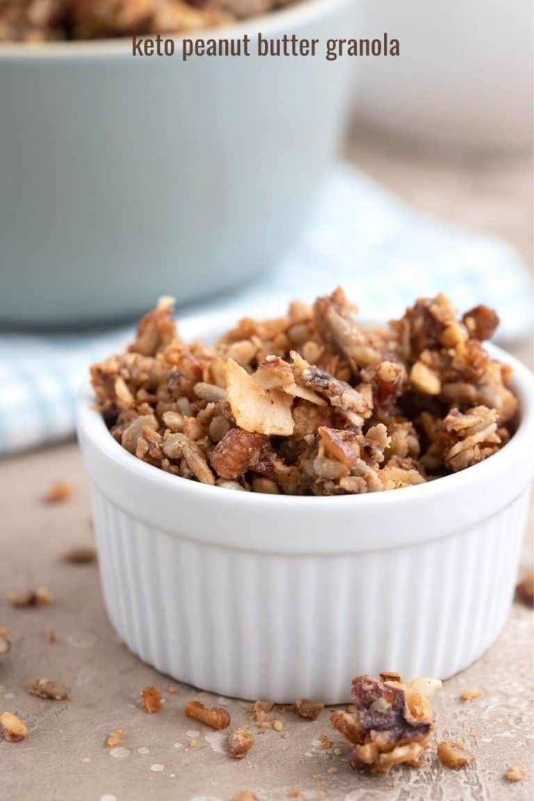 Low carb granola in a white ramekin on a brown table.