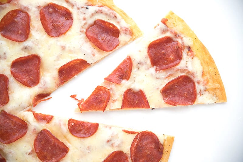 Top down photo of fathead pizza on a white background