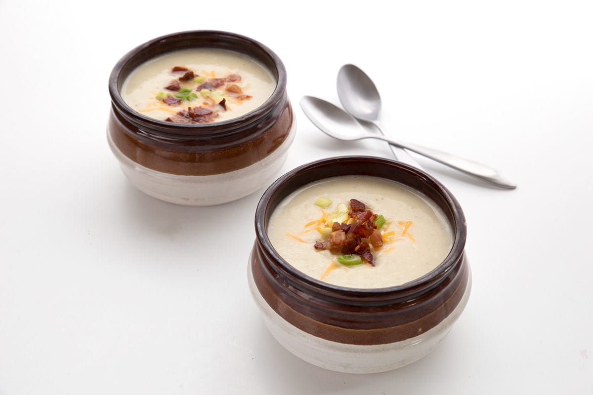 Delicious low carb loaded cauliflower soup in two brown bowls