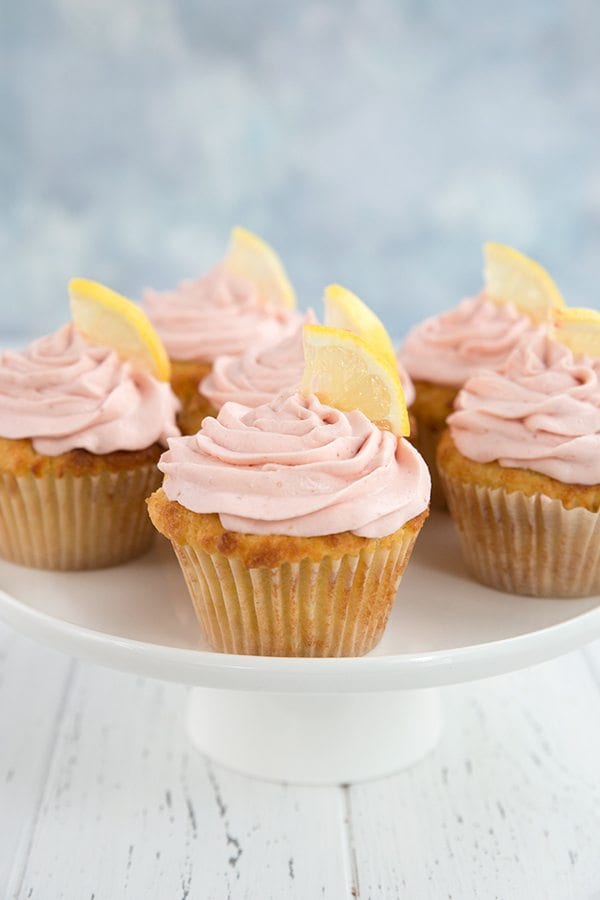 6 low carb Strawberry Lemonade Cupcakes on a white platter with lemon slices