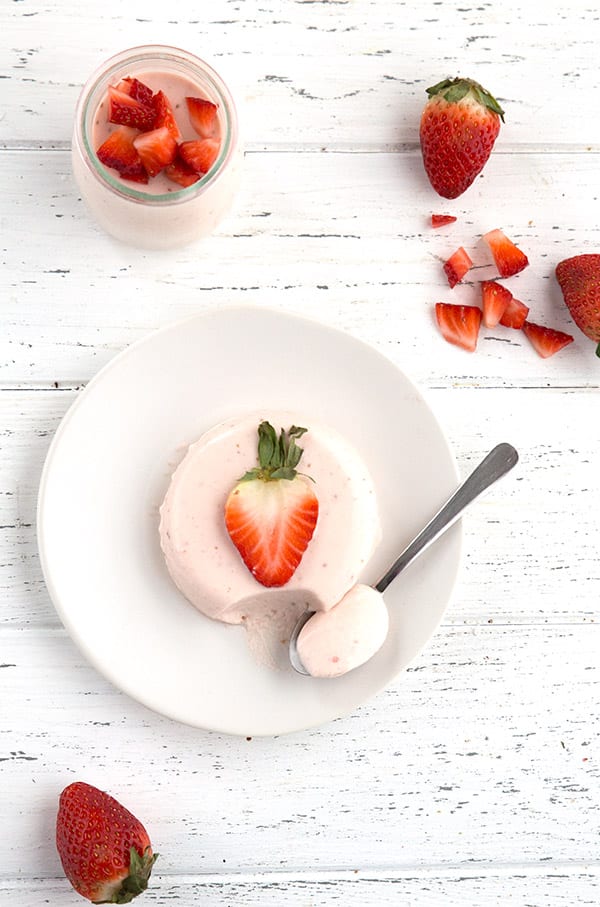 Easy keto and sugar-free panna cotta, top down view on a white table with a spoon