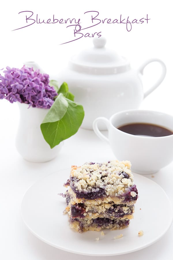 Low Carb Blueberry Crumble Bars in front of flowers and coffee