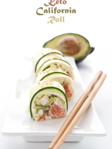 Keto Sushi wrapped in thinly sliced cucumber on a white platter
