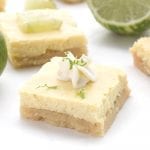 Keto Key Lime Bars with limes and whipped cream. Sugar-free.