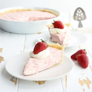 Two slices of strawberry cream pie on a white table