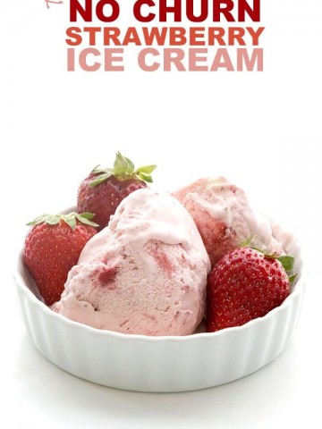 Easy Keto Strawberry Ice Cream in a white dish with strawberries around it.